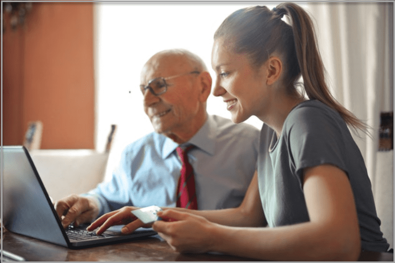 Father and daughter looking at a computer