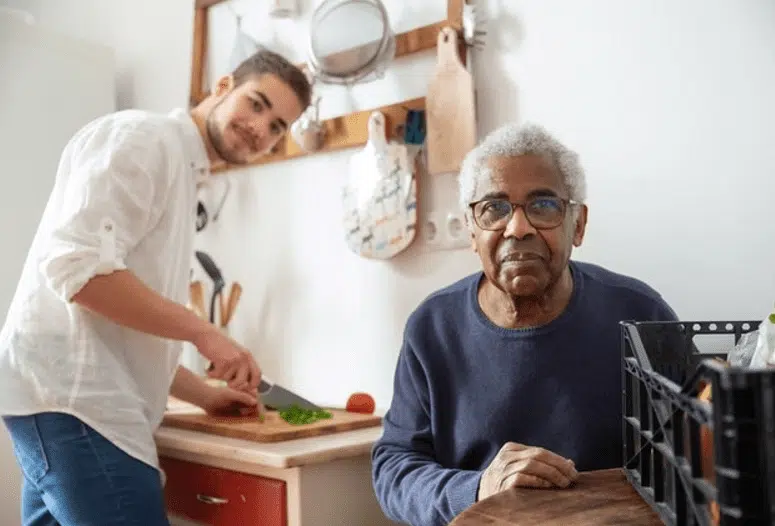 Man helping elderly man